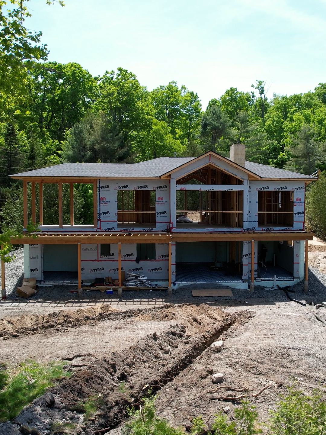 Two-storey ICF walls with timber accents on a summer build